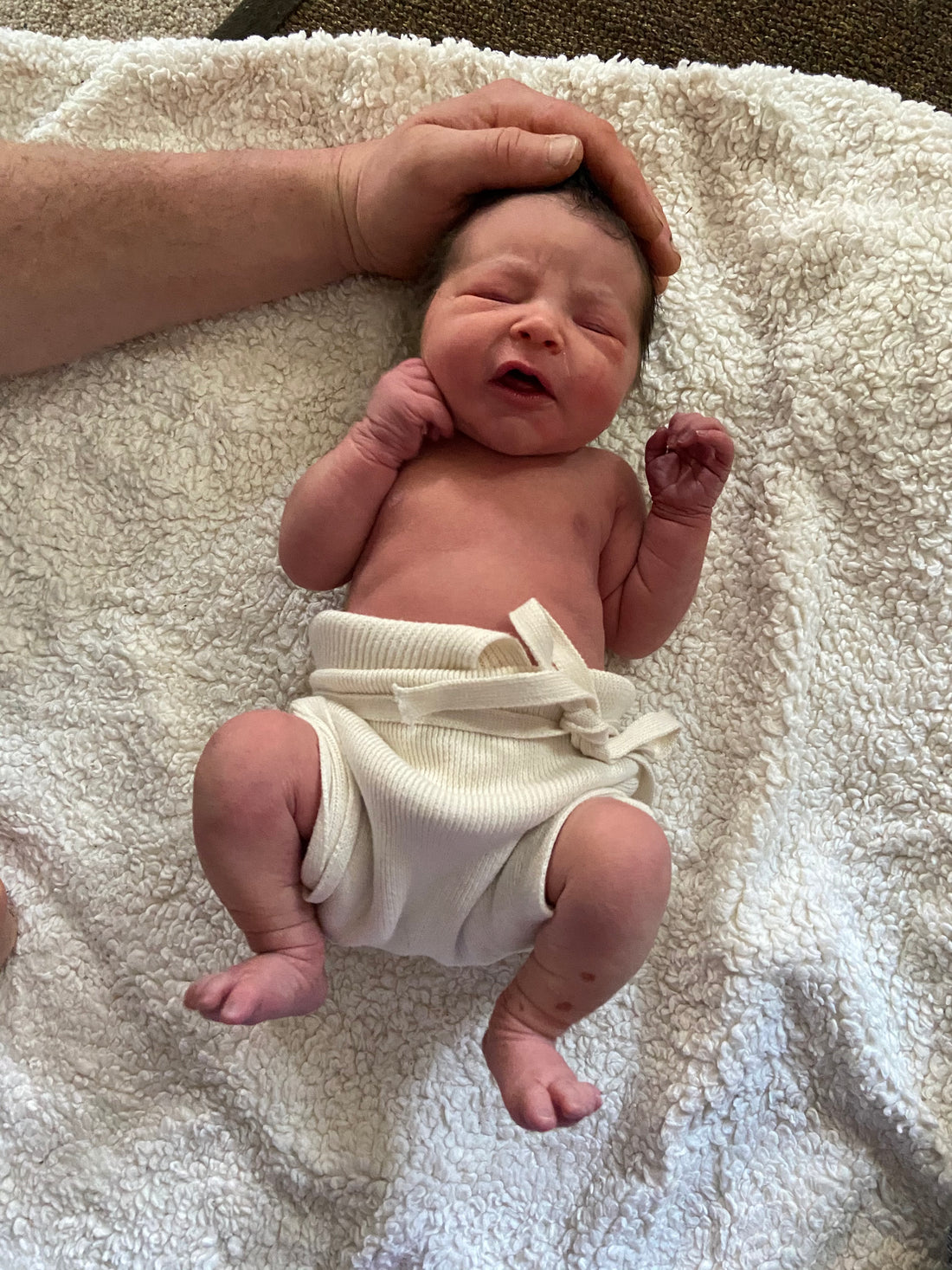 using reusable nappies from birth - newborn nappies, a newborn baby in a Disana tie nappy