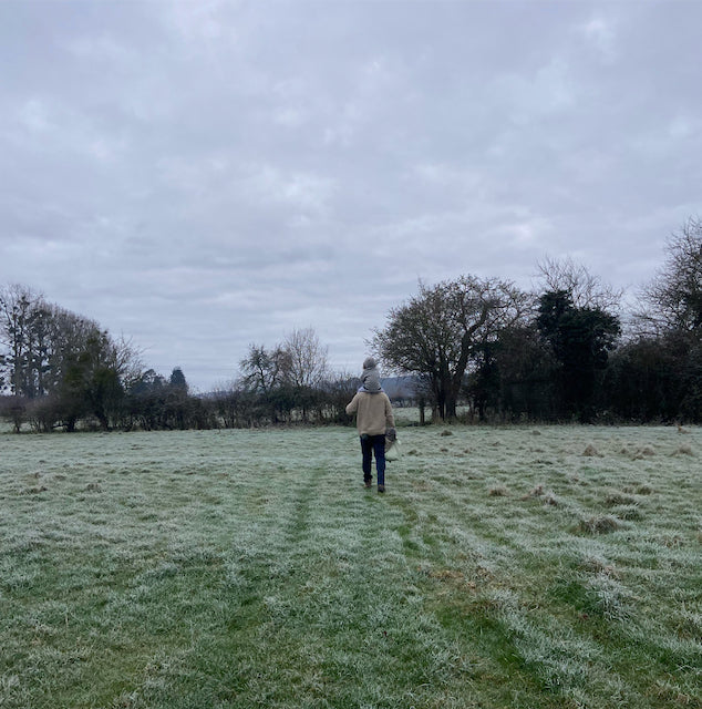 a winter scene baby on dads shoulders in the frost