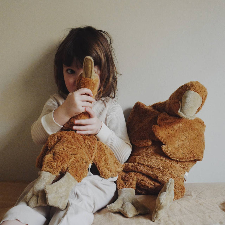 toddler with fluffy organic goose toy from senger-naturwelt