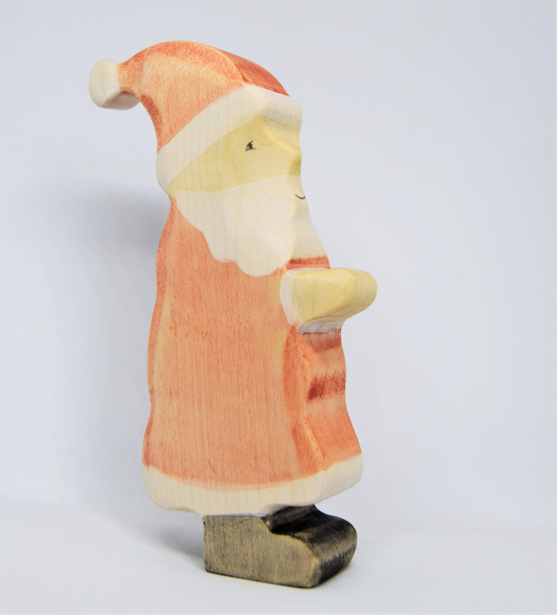 Wooden Santa Claus figurine on a white background