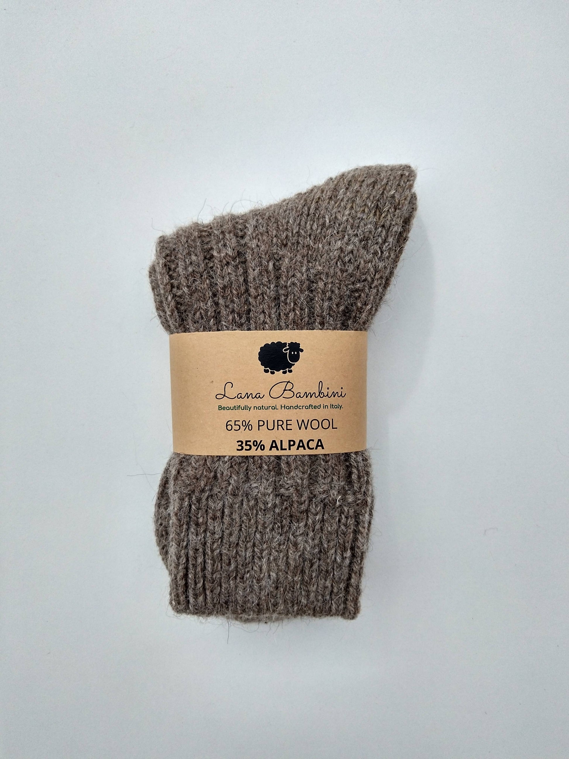 Pair of brown socks with a label on a light gray background