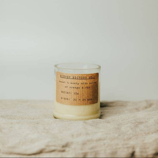 Candle with a label on a textured surface